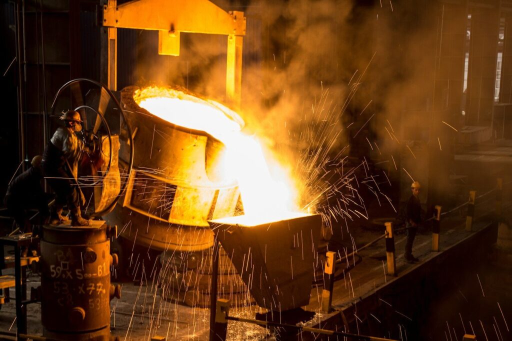 a large piece of metal being poured onto a machine