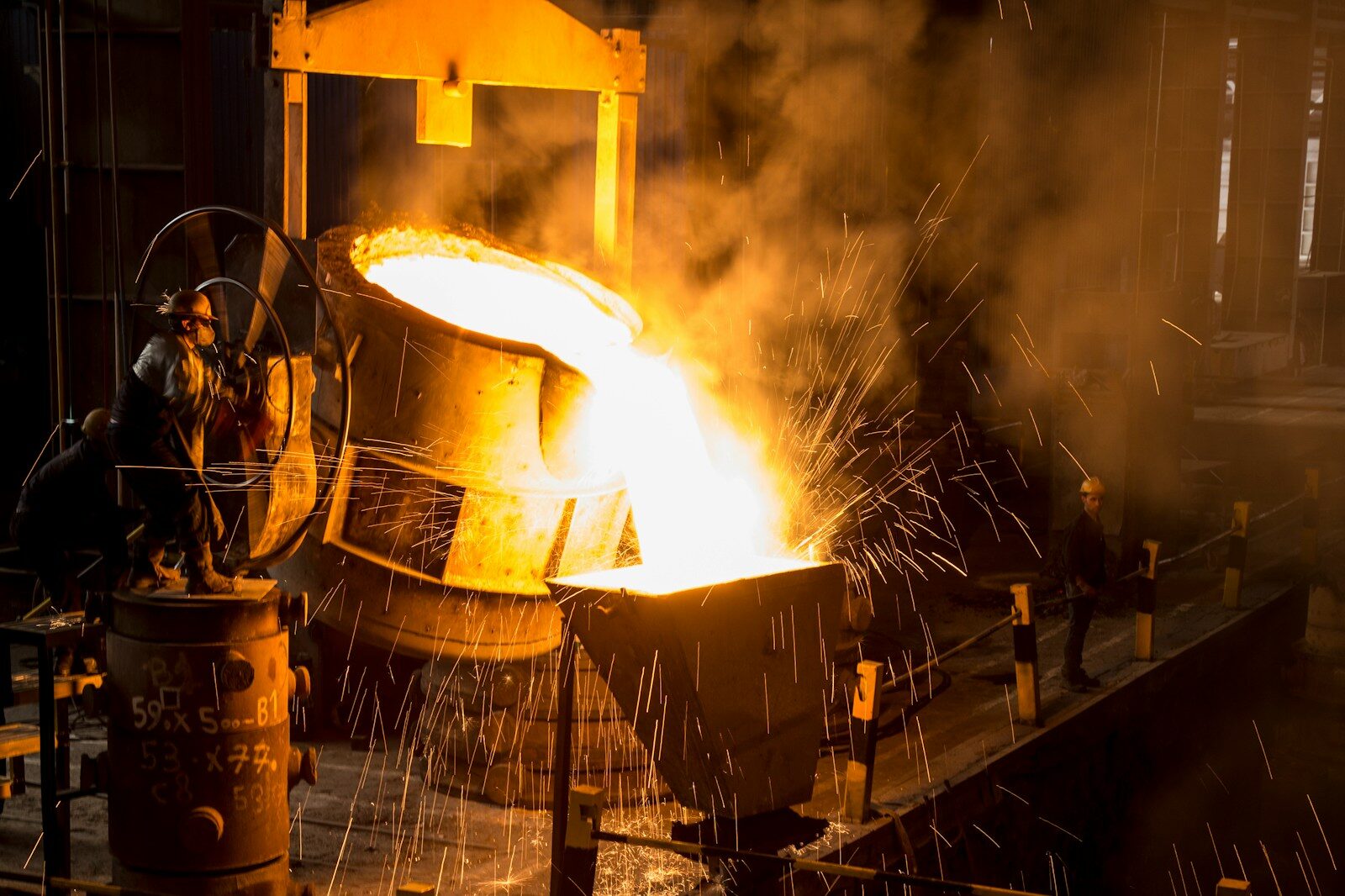 a large piece of metal being poured onto a machine